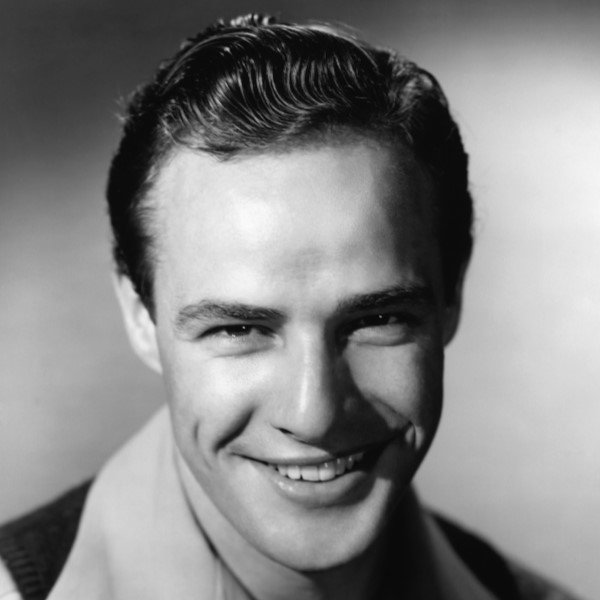 Marlon Brando smiling on black and white photo