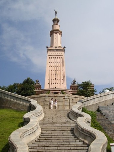 Two ladies are clicking picture with Lighthouse of Alexandria